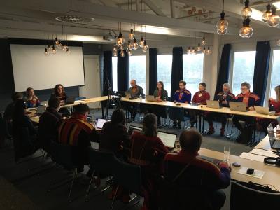 Group of Saami seated in conference