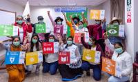Indigenous Women gather with SDG signs